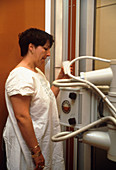 Woman swallowing barium during X-ray examination