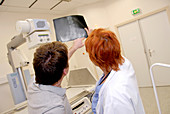 Doctor and patient examining an X-ray