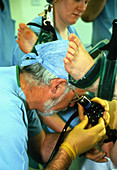 Surgeon examining patient's colon with colonoscope