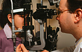 Slit-lamp examination of a young woman's eyes