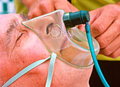 Patient being given oxygen by ambulanceman