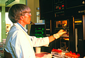 Technician analyses blood using a Coulter counter