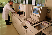 Technician analysing blood using a Coulter counter