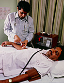 Doctor taking blood sample during drug trial