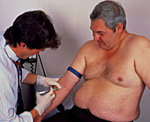 Doctor takes a blood sample from an obese man