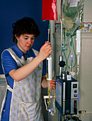 Nurse adjusting an infusion pump