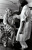 Nurse with elderly man in wheelchair