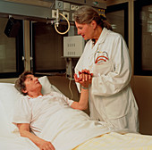 Doctor attends elderly woman in a geriatric ward