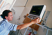 Hospital nurse adjusting heart monitor