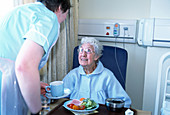 Hospital patient being served food