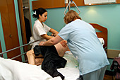 Nurses dressing a patient