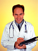 Front view of a male hospital doctor taking notes