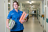 Nurse holding patient records