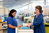 Nurses checking patient notes