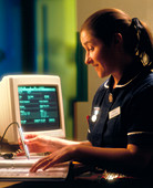 Nurse using a bar code scanner for medical records