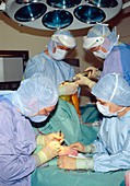 Surgeons operating on knee and wrist at same time
