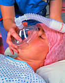 Close-up of woman inhaling anaesthetic gas