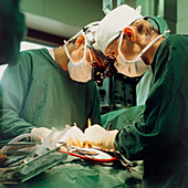 Surgeons performing open heart microsurgery