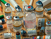 Assorted vials of injectable drugs,with syringes
