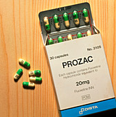 Prozac pack with pills on wooden surface