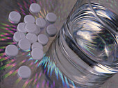Paracetamol painkillers next to glass of water
