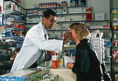 View of a pharmacist examining a woman's eye