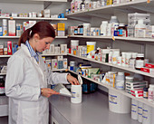 Pharmacist measuring out pills