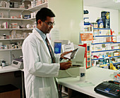 Pharmacist counts tablets for prescription