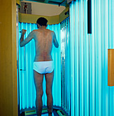 Man undergoing ultraviolet radiation therapy