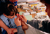 Schoolgirl being vaccinated against rubella