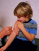 DPT booster vaccination on a young child