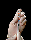 Drawing hepatitis B vaccine into syringe