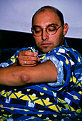 Diabetic self-injecting insulin into his upper arm
