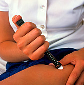 Teenage girl self-injecting with insulin novopen