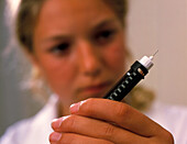 Teenage girl holding an insulin injecting novopen