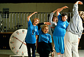 Elderly women attend an aerobics exercise class