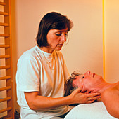 Woman having her neck massaged