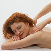 Woman receives a neck and shoulder massage