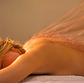 Time-exposure image of a woman having a massage