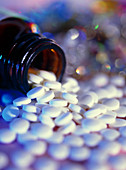 Scattered homeopathy pills from a pill bottle