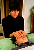 Reiki therapy technique: cupping patient's eyes