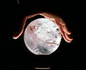 Crystal therapy: rock crystal sphere in man's hand