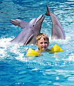Computer art of a boy receiving dolphin therapy
