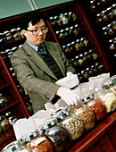 Herbalist in a Chinese herbal medicine pharmacy