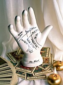 Model palmistry hand with tarot cards and candles