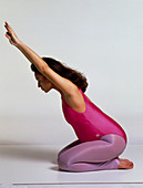 Prenatal exercise: pregnant woman sits stretching