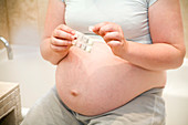 Pregnant woman taking a tablet
