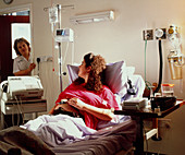 Woman in labour with cardiotocography machine