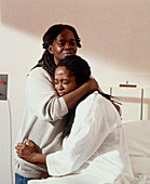 Pregnant woman being comforted during early labour