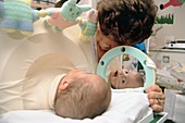 Premature baby in miniature iron lung